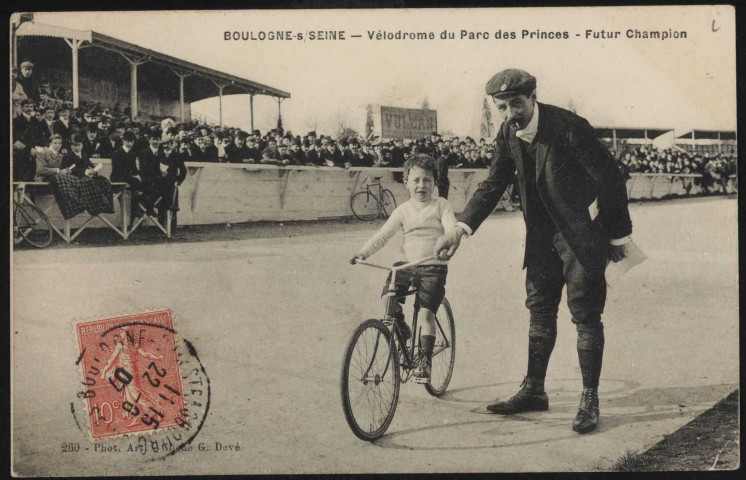 260 - Boulogne-sur-Seine - Vélodrome du Parc des Princes - Futur Champion, Boulogne-Billancourt . quartier des Princes . - vélodrome du Parc des PrincesAu premier plan, un homme tient un jeune garçon qui est sur un vélo. Au second plan, les tribunes remplies.